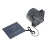 A solar panel is connected to a black fan with a silver grille. The fan is cylindrical with a square base. Voir les images du produit