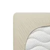 A close-up view of a beige fitted sheet on a mattress. Produktbild-Vorschau