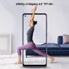 A woman is doing yoga in front of a smartphone displaying her image. Náhľad obrázku produktu