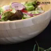 A close-up of a salad in a wooden bowl. Produktbild-Vorschau