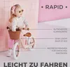 A young girl is shown with a pink balance bike, with text overlays highlighting product features. Produktbild-Vorschau