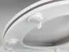 A close-up view of a white toilet seat, showing a detail of the soft-close mechanism. Produktbild-Vorschau