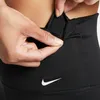 A close-up shot of a person's hands interacting with black athletic leggings. Produktbild-Vorschau