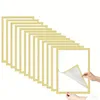 A stack of gold-colored magnetic photo frames with one frame being peeled back by hands. Náhled obrázku produktu
