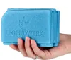 A hand holding a blue foam seat cushion. Produktbild-Vorschau