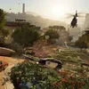 A helicopter flies over a city with buildings and trees. Náhled obrázku produktu