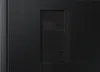 The back of a black electronic device with a textured surface and a recessed panel for ports. Náhľad obrázku produktu