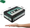 A tin box designed to look like a retro cassette tape is shown with dimensions indicated. A hand is placed below it to show scale. Produktbild-Vorschau