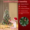 A young girl in a Santa hat decorates a Christmas tree. Voir les images du produit