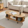 A living room scene featuring a coffee table with decorative items and books, placed on a rug in front of a sofa. Anteprima dell’immagine prodotto