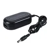 A black AC power adapter with a coiled cable and a DC output connector is shown against a white background. Náhled obrázku produktu
