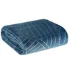A folded blue blanket with a gold geometric pattern is shown against a white background. Podgląd zdjęcia produktu