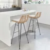 Two rattan bar stools with beige cushions are placed at a white kitchen island. Produktbild-Vorschau