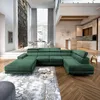A spacious, modern living room with a large green sectional sofa as the focal point, a dining area in the background, and a glimpse of a kitchen. Produktbild-Vorschau