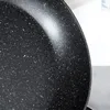 A close-up view of the speckled interior of a black frying pan. Anteprima dell’immagine prodotto