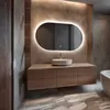 A modern bathroom with a vanity, sink, and illuminated mirror. Produktbild-Vorschau