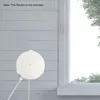 A white router holder is mounted on a light gray, horizontally paneled wall next to a window with trees visible outside. Náhled obrázku produktu