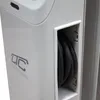A close-up view of a white electrical device with a coiled black cable stored in a recessed compartment. A logo and text are visible on the side of the device. Náhled obrázku produktu