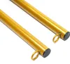 Two golden metal poles with black caps and rings on a white background. Podgląd zdjęcia produktu