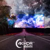 A television displaying a vibrant space scene, placed on a road with a starry sky background. Produktbild-Vorschau
