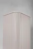 A close-up view of the top corner of a tall, beige cabinet with vertical fluting. Produktbild-Vorschau