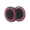 Two black ear pads with red adhesive tape on a white background. Náhled obrázku produktu