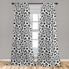 Two curtains with a repeating soccer ball pattern hanging in front of a window. Produktbild-Vorschau