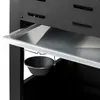 A close-up view of a metal drip tray and a small black bucket hanging from a grill. Produktbild-Vorschau