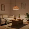 A living room scene with a sofa, coffee table, and a pendant lamp. Podgląd zdjęcia produktu
