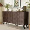A modern sideboard with a textured wood-grain finish, decorated with a vase of flowers, a coffee maker, and other decorative items, placed in a living or dining room setting. Produktbild-Vorschau