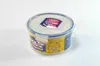 A round Lock & Lock food storage container filled with yellow food, possibly corn or pineapple, against a white background. Voir les images du produit