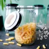 A glass jar filled with pasta, with a few pieces of pasta scattered around it. Produktbild-Vorschau