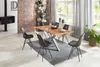 A dining room with a wooden table and chairs, set up for a meal. Produktbild-Vorschau