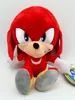 A plush toy of the character Knuckles the Echidna from the Sonic the Hedgehog franchise, sitting down against a white background. Produktbild-Vorschau