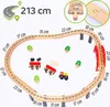 A wooden train track set with trains, trees, and a bridge, with measurements indicated. Produktbild-Vorschau