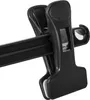 Close-up of black plastic clothes clips on a hanger bar. Produktbild-Vorschau