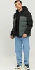 A man wearing a puffer jacket and jeans, posing against a plain background. Produktbild-Vorschau