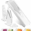 A white mandoline slicer set with various attachments and sample sliced vegetables shown below. Podgląd zdjęcia produktu