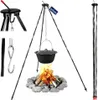 A campfire tripod with a pot hanging over a fire, with additional product shots on the side. Produktbild-Vorschau