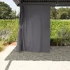 A grey curtain hangs from a gazebo, partially obscuring the view of a garden. Anteprima dell’immagine prodotto