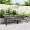 A black double garden bench sits on a paved patio in front of a wooden fence and lush green bushes. Produktbild-Vorschau
