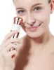 A woman is holding a facial trimmer to her cheek. Náhled obrázku produktu