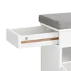 A close-up view of a white shoe cabinet with a gray upholstered seat, showing an open drawer. Produktbild-Vorschau