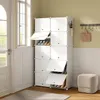 A white shoe rack with multiple compartments is shown in a room with natural light coming from a window. Produktbild-Vorschau