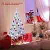 A decorated Christmas tree with gifts and smaller trees in a cozy room setting. Produktbild-Vorschau