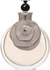 A perfume bottle with a floral design on a white background. Voir les images du produit