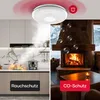 A split image showing a smoke detector in a kitchen with smoke and a fireplace with CO bubbles, illustrating its dual functionality. Produktbild-Vorschau