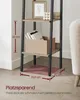 A close-up view of a ladder shelf with dimensions indicated, placed on a wooden floor next to a chair. Text highlights its space-saving design. Produktbild-Vorschau