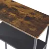 A close-up view of a shelf unit with a wood-grain top shelf and a black lower shelf, supported by gray metal legs. Produktbild-Vorschau