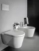 A modern bathroom with a wall-mounted toilet and bidet. Produktbild-Vorschau